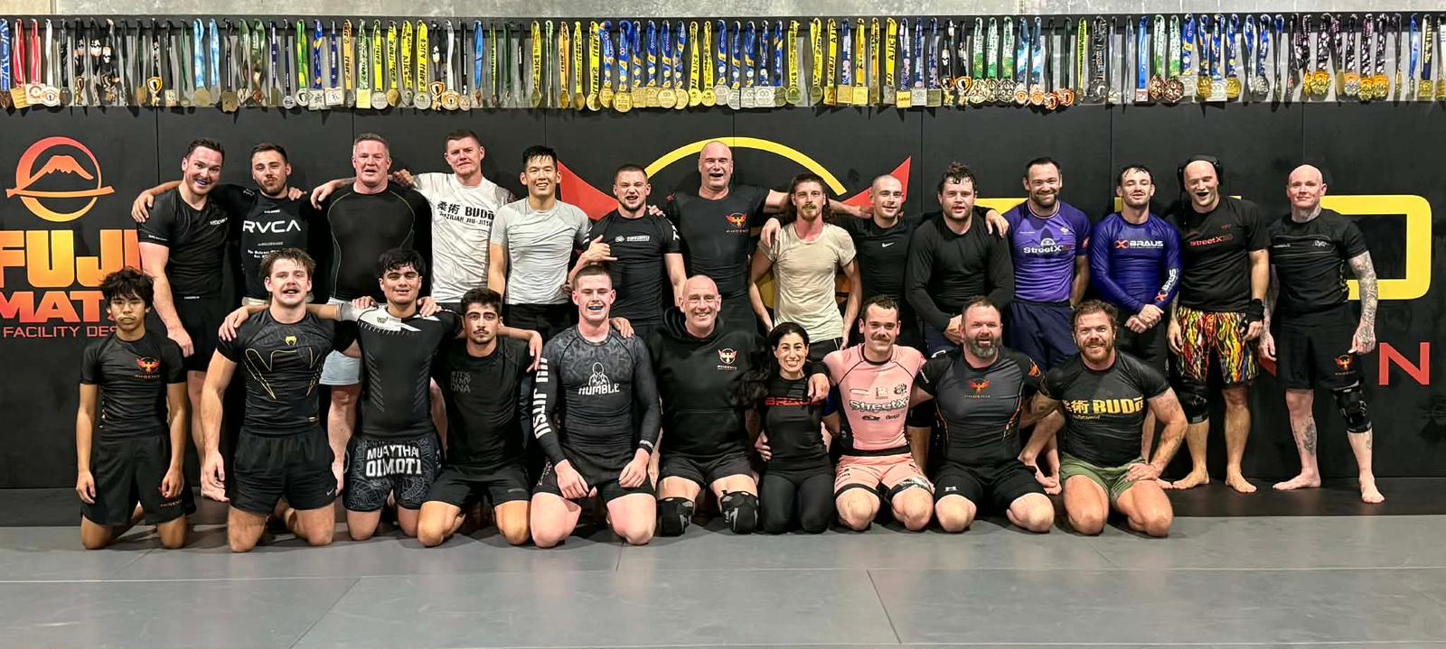 Adults rolling and drilling Brazilian Jiu-Jitsu at Phoenix Training Centre