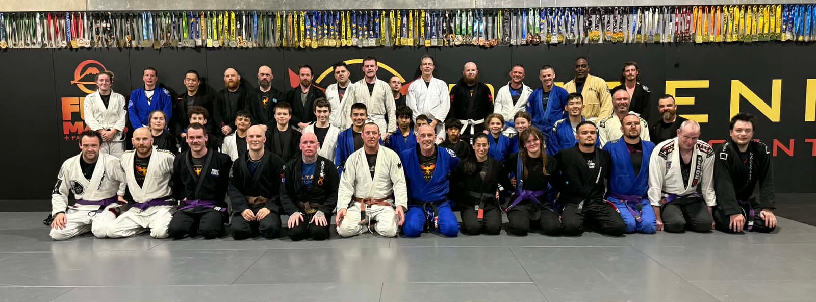 Phoenix Training Centre full team group photo with trophy wall